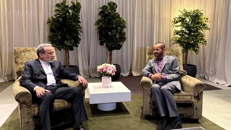 Iranian Foreign Minister Abbas Araghchi speaks with Omani Foreign Minister Badr al-Busaidi.