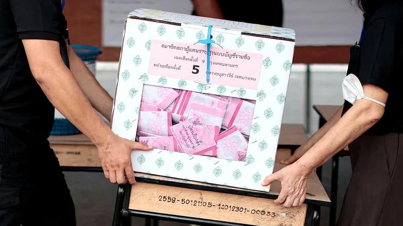 Electoral officials handle a sealed ballot box on the day of the general election at a polling station in Bangkok, Thailand, February 8, 2026. REUTERS/Patipat Janthong