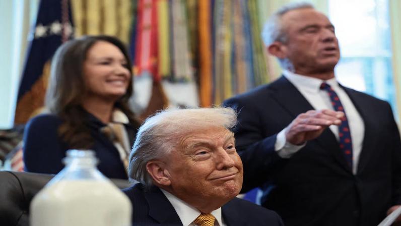 U.S. President Donald Trump listens as U.S. Health and Human Services (HHS) Secretary Robert F. Kennedy Jr. speaks during the signing ceremony for the Whole Milk for Healthy Kids Act in the White House in Washington