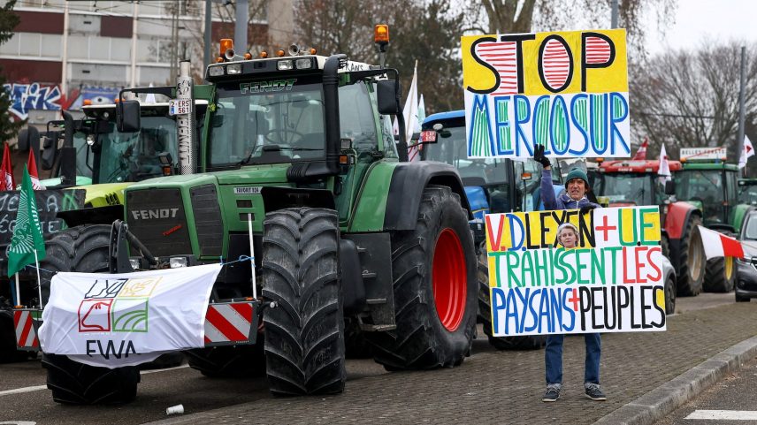 A man holds placards, as French farmers from FNSEA and Jeunes Agriculteurs farm unions take part in a demonstration to protest against the EU-Mercosur free trade agreement, in Strasbourg, France, January 20, 2026.