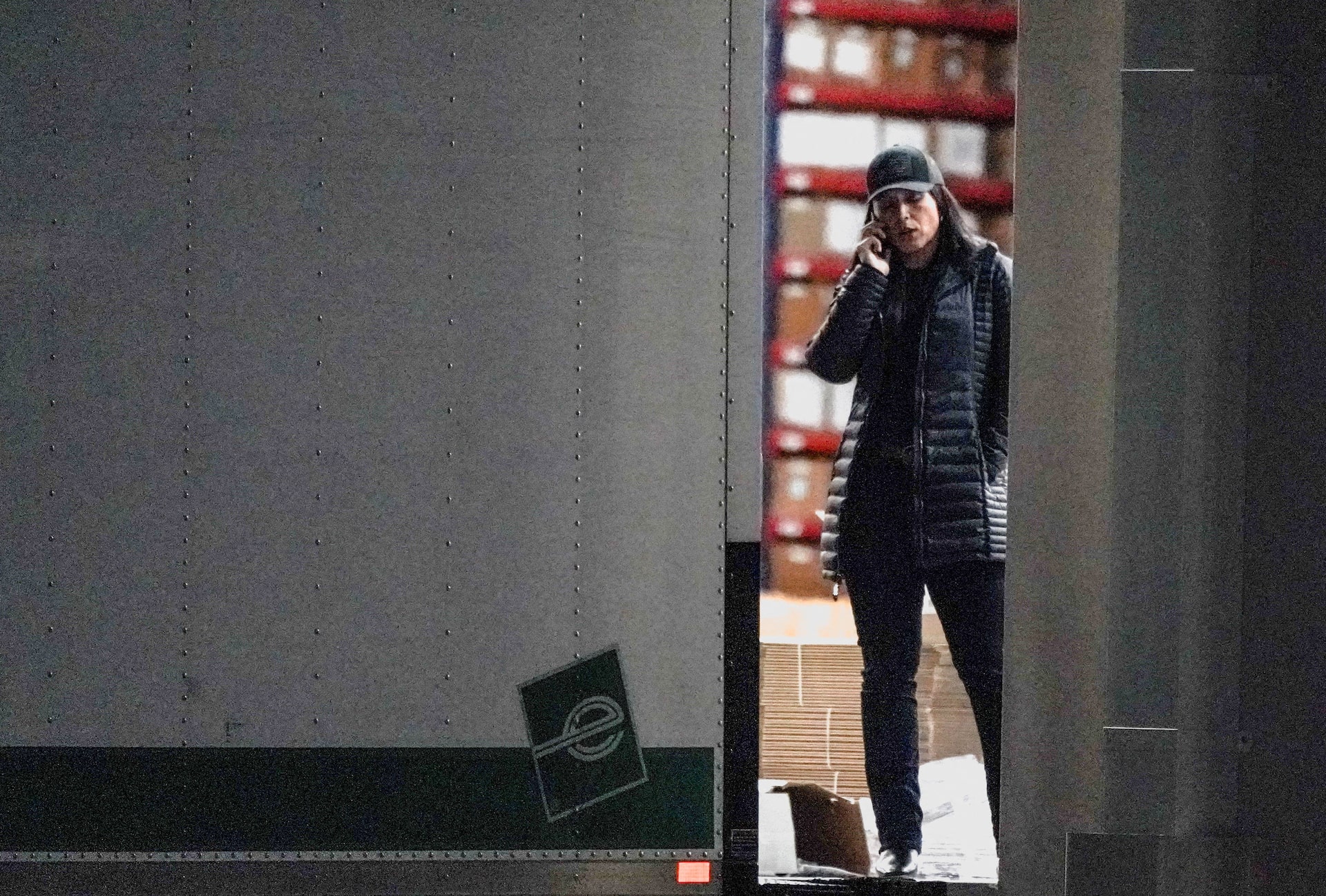 United States Director of National Intelligence Tulsi Gabbard speaks on the phone while standing at the edge of a truck loading bay after the Federal Bureau of Investigation (FBI) executed a search warrant for the Fulton County Election Hub and Operation Center in relation to the 2020 election, according to a law enforcement official familiar with the matter, in Union City, Georgia, U.S. January 28, 2026. REUTERS/Elijah Nouvelage.