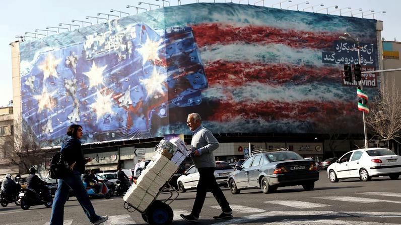 People walk past an anti-U.S. billboard in Tehran, Iran, February 19, 2026. Majid Asgaripour/WANA (West Asia News Agency) via REUTERS