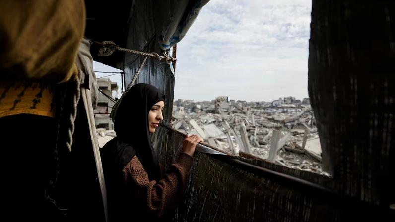 Palestinian mother of three Eatedal Rayyan returns to her war-damaged home in northern Gaza Strip following medical treatment in Egypt