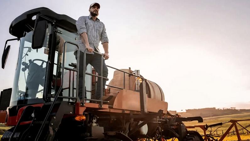 Trabalhador rural em máquina agrícola no campo