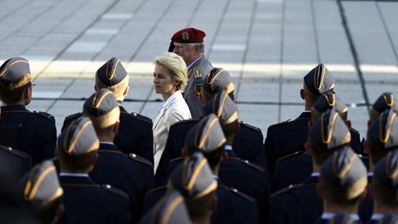 German Defense Minister Ursula von der Leyen inspects the honor guard during a swearing-in ceremony of German Bundeswehr soldiers at the Bendlerblock in Berlin on July 20, 2015.