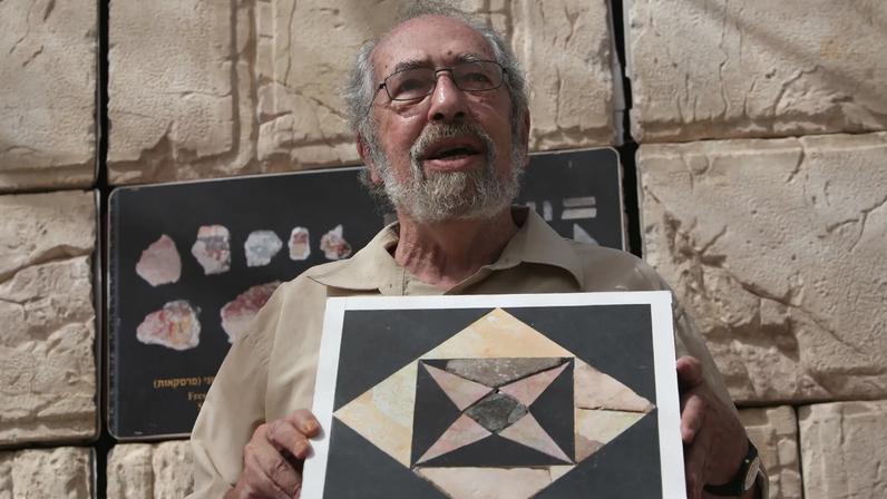 Dr. Gabriel Barkay showing a restored floor tile in east Jerusalem on September 6, 2016.