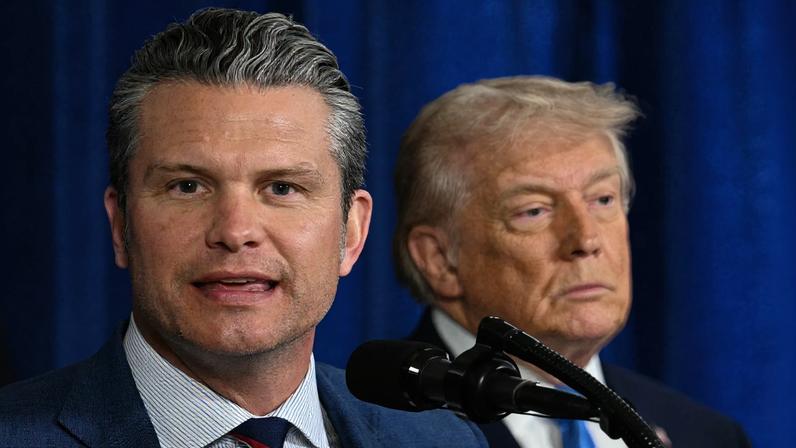 US President Donald Trump (R) looks on as US Secretary of Defense Pete Hegseth speaks to the press following US military actions in Venezuela