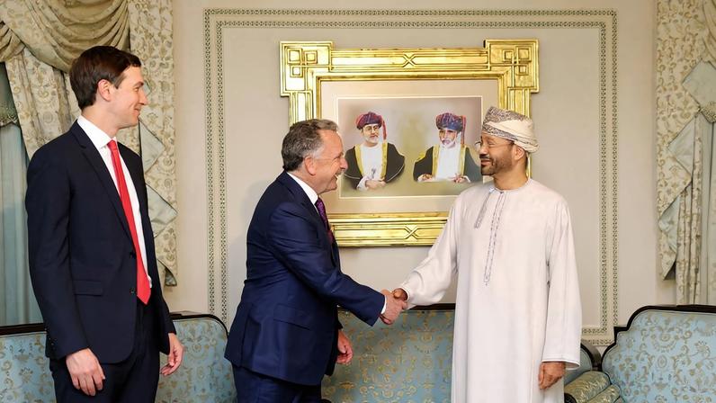 Jared Kushner looks on as U.S. special envoy Steve Witkoff shakes hands with Omani Foreign Minister Sayyid Badr al-Busaidi.