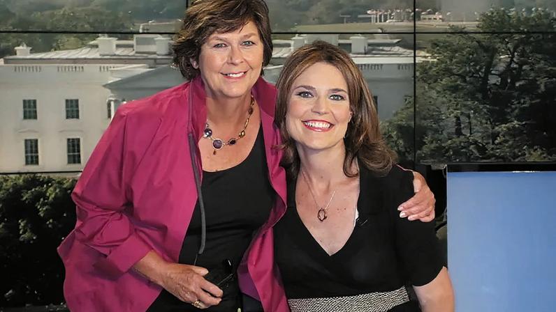 Nancy Guthrie and Savannah Guthrie posing together in front of a screen displaying the White House.