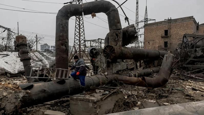 Employees repair sections of the Darnytska thermal power plant damaged by Russian airstrikes in Kyiv.