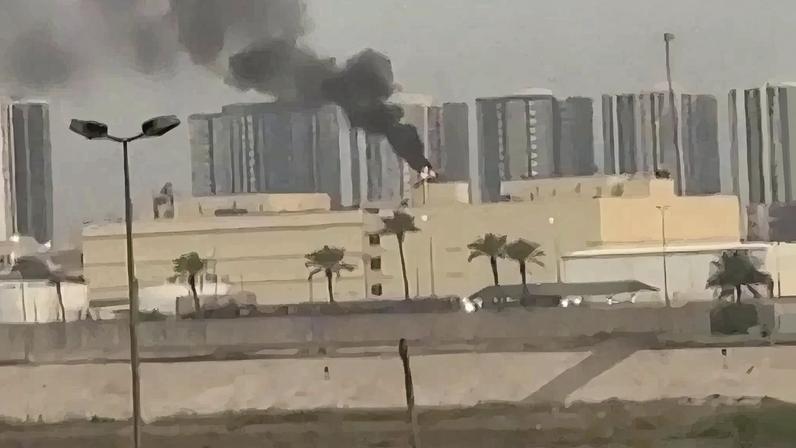 This video grab taken from UGC images posted on social media shows smoke billowing from the US embassy in Baghdad's fortified "Green Zone" following a reported drone strike on March 14, 2026. A drone struck the US embassy in Baghdad on March 14, an Iraqi security official said, as an AFP journalist saw smoke rising from the complex. Iraq, long a proxy battleground between the United States and Iran, was quickly dragged into the Middle East war triggered by US and Israeli strikes on Iran on February 28. (Photo by various sources / AFP) / RESTRICTED TO EDITORIAL USE - MANDATORY CREDIT AFP - SOURCE: UGC / UNKNOWN - DISTRIBUTED AS A SERVICE TO CLIENTS - NO RESALE