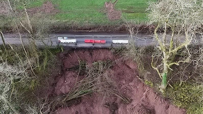 BBC Drone shows the scale of the landslip, which has caused a vertical edge immediately next to the now-closed road