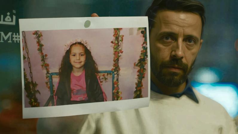 A photo of five-year-old Hind Rajab is taped to a wall in the Ramallah office of the Palestinian Red Crescent society in The Voice of Hind Rajab.