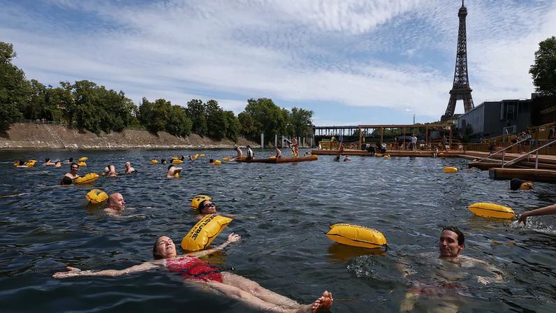 People swim in the Seine River after it reopened to the public in Paris on July 5, 2025.