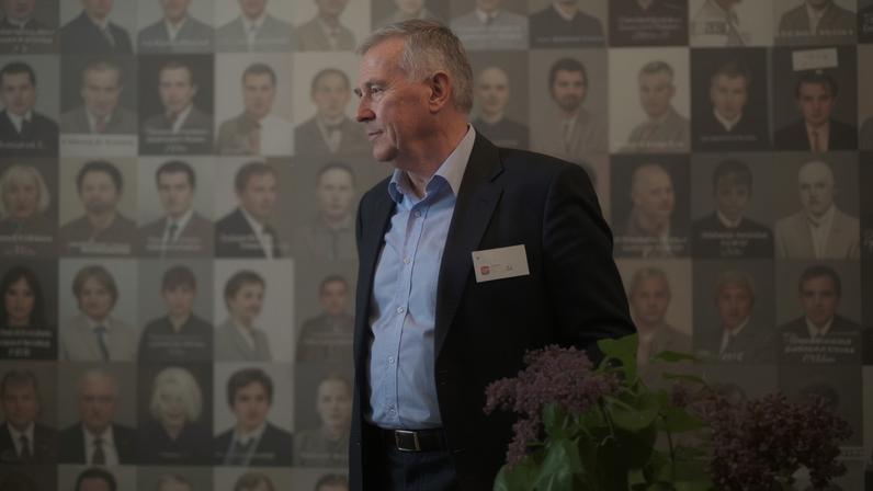 A person is seen through photographs of prisoners at a former KGB prison, now a museum, in Vilnius, Lithuania, in 2015.