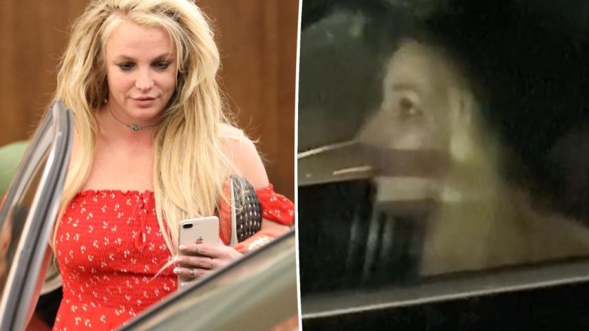 Britney Spears in a blazer, sunglasses, and carrying a handbag and phone.