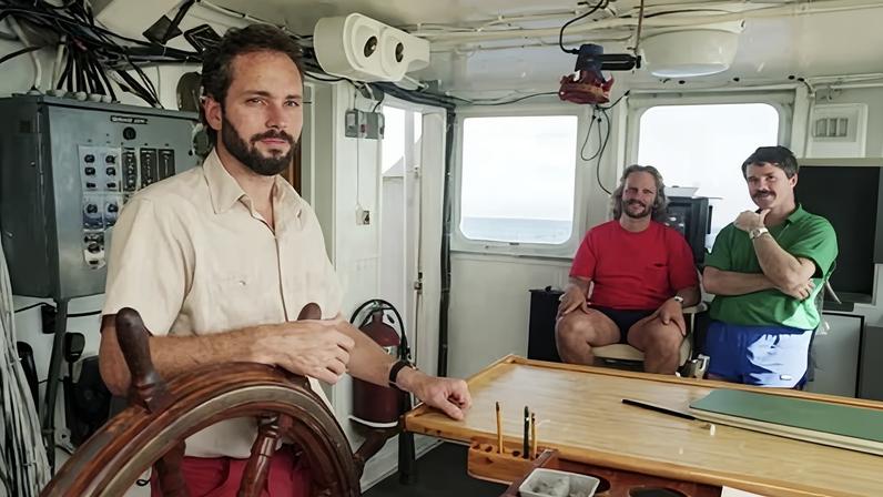 Tommy Thompson stands at the helm of the Arctic Explorer in 1991.