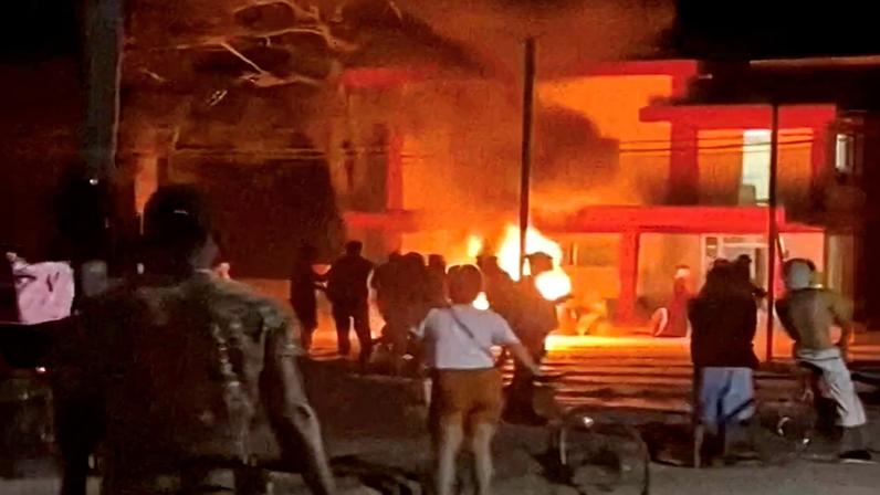 Anti-government protesters look on as a fire burns at a Communist Party office in Moron, Cuba, in this screengrab from video released on March 14, 2026 and obtained from social media.