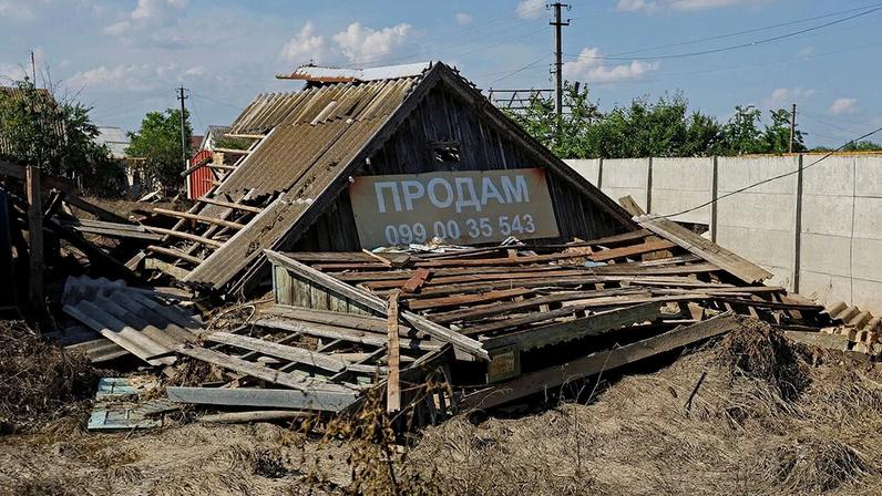 For sale sign on a destroyed house in Hola Prystan, Kherson region