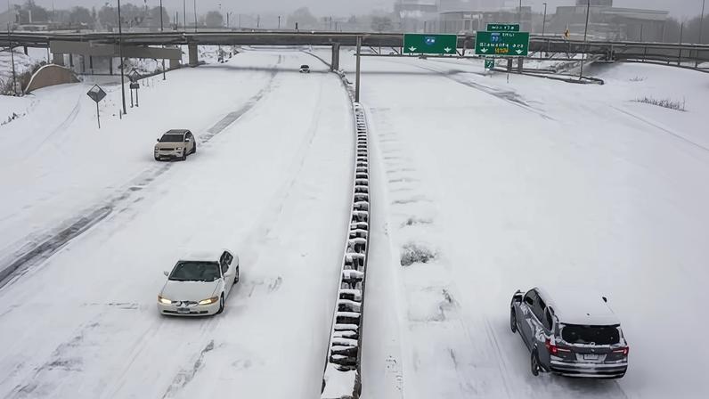 People drive on a snow-covered freeway during a snow storm Sunday in Minneapolis, Minnesota.