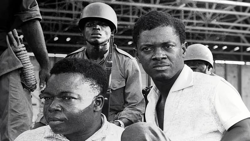 Soldiers stand guard over Patrice Lumumba (right) his associated Joseph Okito after their arrest in December 1960.