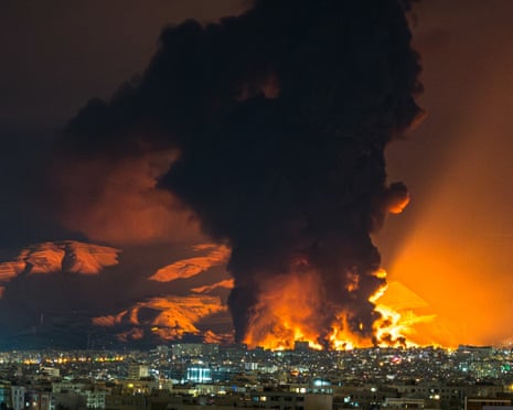 ‘My chest has burned and I can barely breathe’: Smoke and flames rise above Tehran after a strike on an oil depot at the weekend.
