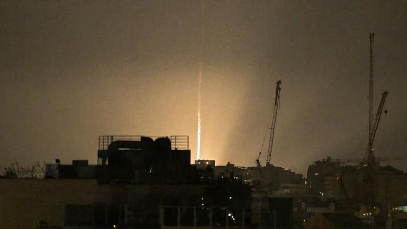 The sky is illuminated as an Iranian missile lands in Israel, amid the U.S.-Israeli conflict with Iran, as seen from Tel Aviv, Israel, March 12, 2026. REUTERS/Dylan Martinez