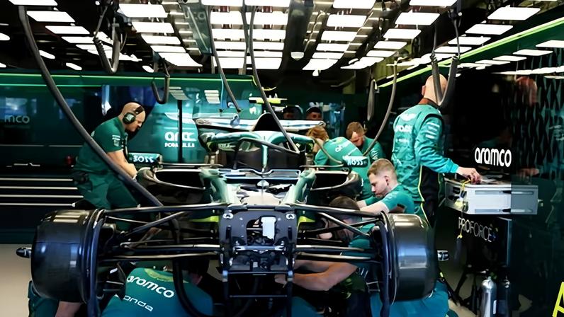 Fernando Alonso's Aston Martin car being worked on by mechanics at the Albert Park Circuit, Melbourne.