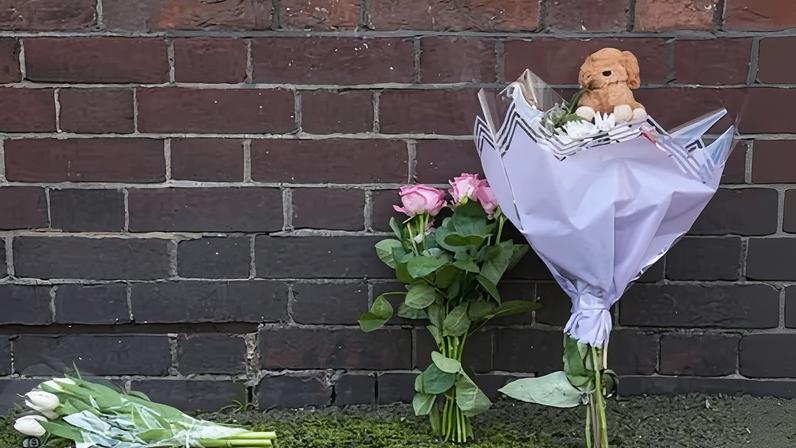 Flowers and a toy animal left near the Peabody Estate building in Horseferry Road in central London, after a baby girl fell from height.