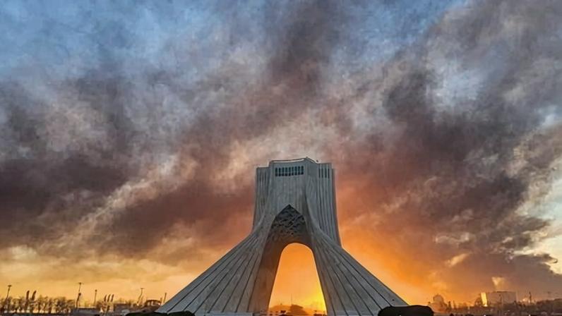 Smoke rises up behind Azadi, or Freedom Tower, on Tuesday after a US-Israeli military strike on Tehran.