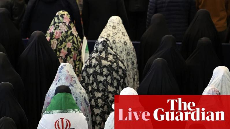 An Iranian woman wearing Iran’s national flag takes part in Eid al-Fitr prayers in Tehran.