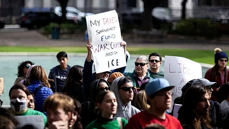 A protester holds a sign during a demonstration against ICE outside city hall in Houston, Texas, on 10 January 2026.