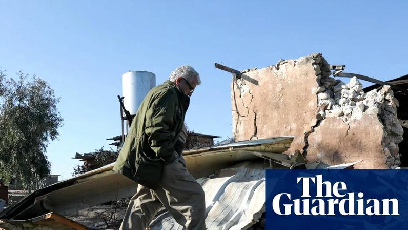 A member of the Kurdistan Democratic Party of Iran inspects a damaged building after an Iranian cross-border attack in the town of Koye in the autonomous Kurdish region of northern Iraq.