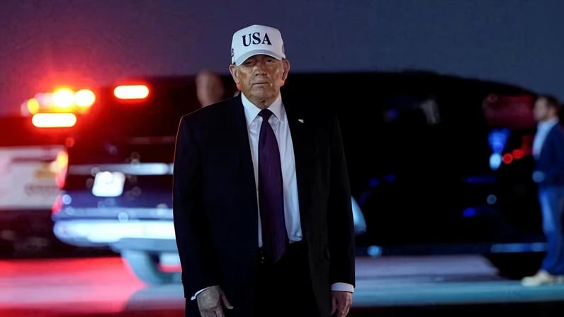 Donald Trump looks on after disembarking Air Force One at Palm Beach international airport in Florida, on 27 February 2026.