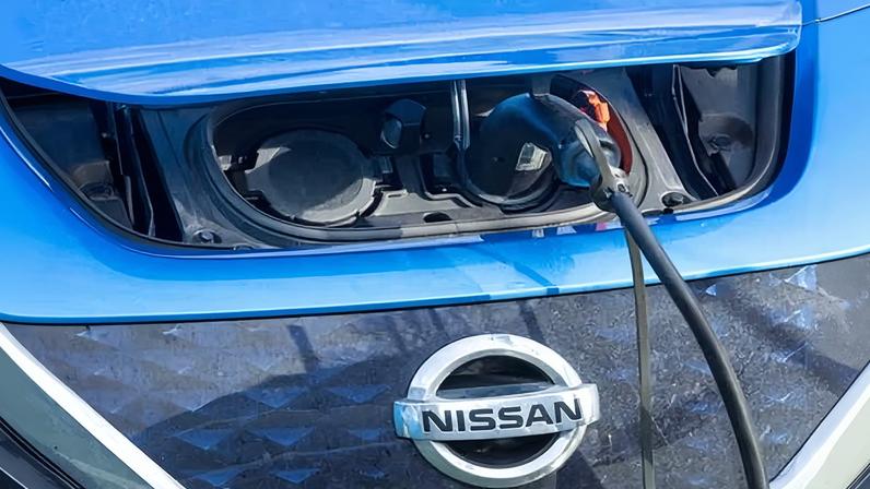 A blue Nissan Leaf electric car charging in Edinburgh