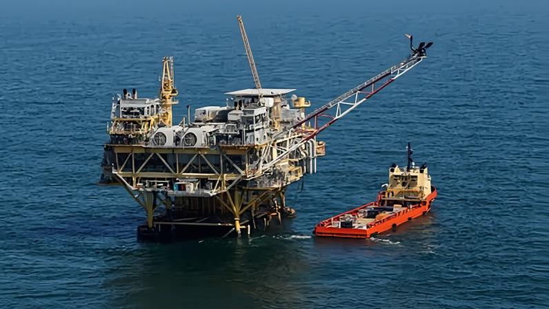 A supply vessel boat sits near an oil rig in the Gulf of Mexico, off the coast of Louisiana, in 2011.