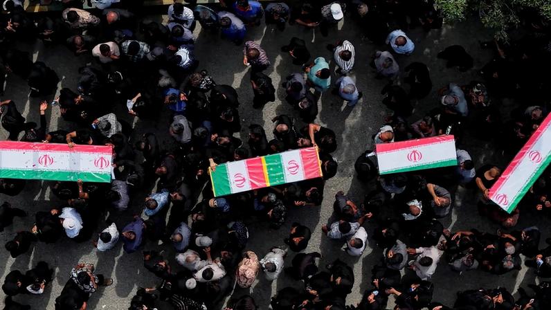 People carry coffins as they attend the funeral of the victims following an Israeli strike on a school, amid the U.S.-Israeli conflict with Iran, in Minab, Iran, March 3, 2026. Amirhossein Khorgooei/ISNA/WANA (West Asia News Agency) via REUTERS