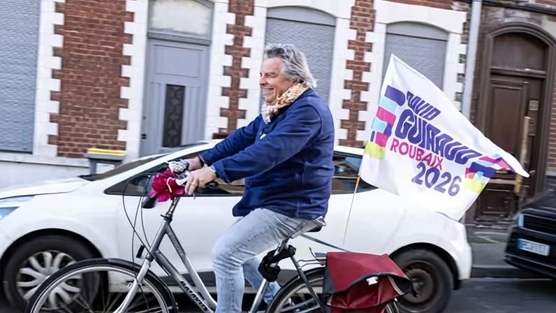 A supporter of La France Insoumise rides about distributing leaflets in Roubaix on Tuesday.