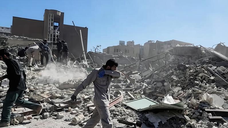 People inspect the ruins of a police station hit in Tehran on Monday as the US and Israel continued their strikes against Iran.