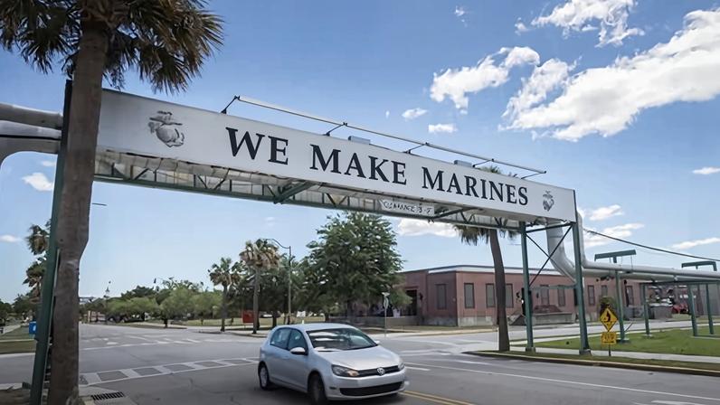 A car drives under a sign that states the sole purpose of the Marine Corps recruiting depot on 11 May 2022, in Parris Island, South Carolina.