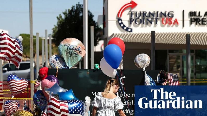 People gather at a makeshift memorial for Charlie Kirk outside of the Turning Point USA headquarters in Phoenix, Arizona on 14 September 2025.