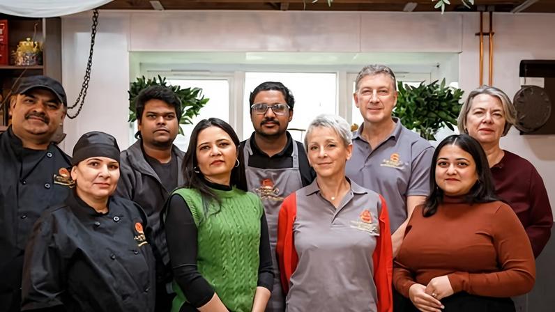‘It’s guilty under proven innocent’ … Mandira Moitra Sarkar (fourth left) with employees at Mandira’s Kitchen, which was raided in September.