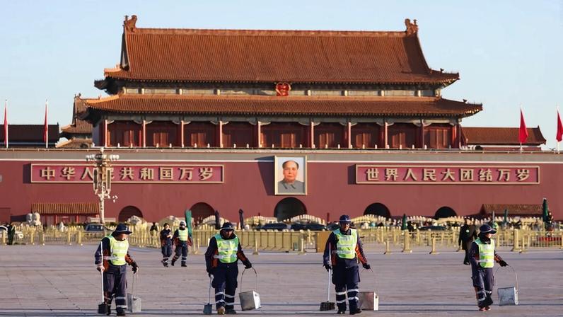 Sanitation workers lined up to work in front of Tiananmen Square before a plenary session of China’s National People’s Congress at the Great Hall of the People in Beijing.