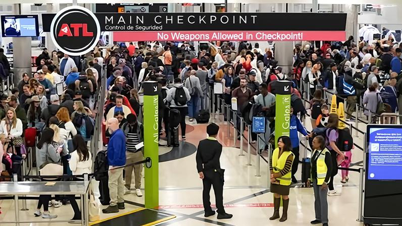 Travelers wait in long lines at Hartsfield-Jackson Atlanta international airport.