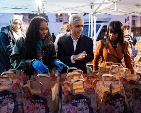 Sadiq Khan (centre) prepares to hand out dinner packages at an 'Open Iftar' Ramadan dinner event at Trafalgar Square in London earlier this week
