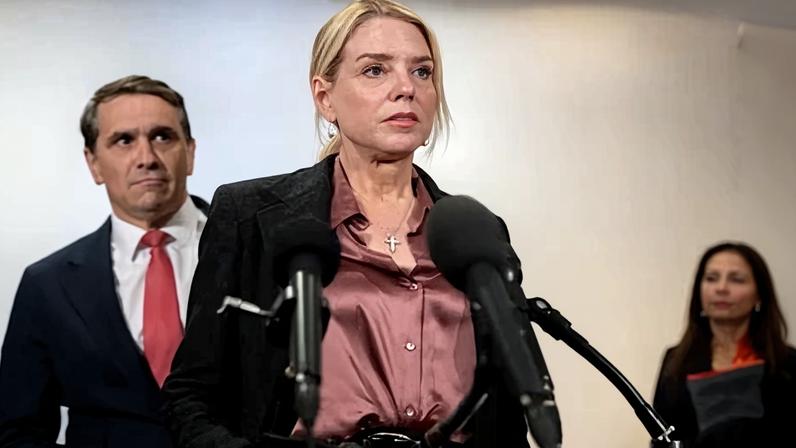Todd Blanche stands behind Pam Bondi as she speaks to reporters following a closed briefing on Jeffrey Epstein