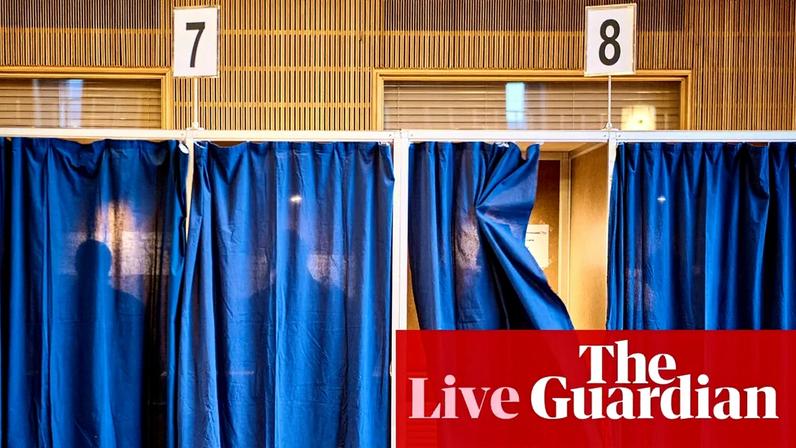 People cast their votes at a polling station at Aarhus City Hall, on 24 March.