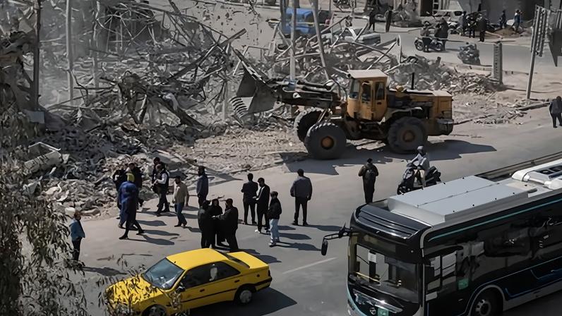 A loader works among the ruins of a destroyed diplomatic police station in Tehran, Iran, on 4 March 2026.