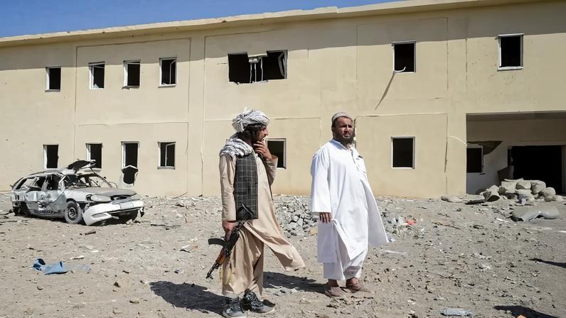 Taliban security personnel stand at the site of a Pakistani airstrike near a refugee registration center in Kandahar, Afghanistan, on Feb. 28.