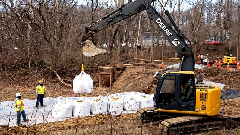Workers build a cofferdam to stop the flow of raw sewage into the Potomac River after a massive sewage pipe rupture in Glen Echo, Md., Friday, Jan. 23, 2026.